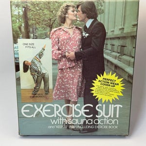 May include: Vintage exercise suit box with a couple kissing on the front. The box features the text "EXERCISE SUIT with sauna action" and "ONE SIZE FITS ALL". A smaller image shows a person wearing a silver exercise suit.