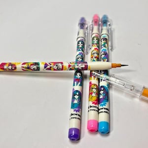 May include: A collection of colorful mechanical pencils with cartoon character designs. The pencils have white barrels with illustrations and text, and come in various colors like purple, pink, and blue. One pencil is disassembled, showing the lead and internal mechanism.