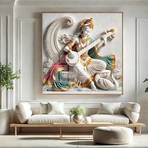 May include: A framed relief sculpture of a seated figure playing a stringed instrument, adorned in white, gold, teal, and red. The artwork features a swan and flowing lines, set against a neutral background. The scene is part of a living room setting with white sofas and plants.