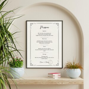 Może przedstawiać: Oprawione menu z dekoracyjnymi narożnikami, z tytułem w stylu ręcznym i szczegółowymi opisami potraw. Menu zawiera przystawki, dania główne, desery i napoje. Na dole menu znajdują się imiona "Olivia & Shawn" i symbol serca.