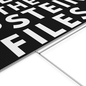 May include: Black and white sign with the text "THE FILES". The sign is made of a corrugated plastic material and has a metal stake attached for easy placement in the ground. The text is in a bold, sans-serif font.