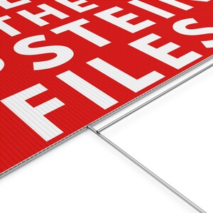 May include: Red and white sign with the words "THE FILES" printed in large, bold, white letters. The sign is made of corrugated plastic and has a metal stake for ground placement.