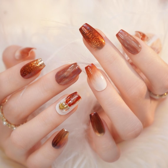 20 Thanksgiving Nail Ideas for a Festive Fall Manicure 16 Amber Marble and Gold