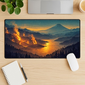 May include: A rectangular mousepad featuring a landscape scene with a mountain, lake, and forest. The artwork depicts a sunset with orange and yellow hues, with a mountain in the background. The mousepad is black.