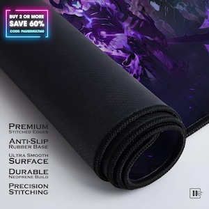 May include: A rolled black mouse pad with a purple graphic design featuring a dark figure. The text reads: PREMIUM STITCHED EDGES, ANTI-SLIP RUBBER BASE, ULTRA SMOOTH SURFACE, DURABLE NEOPRENE BUILD, PRECISION STITCHING. BUY 2 OR MORE SAVE 60% CODE: PAUSEMULTI60
