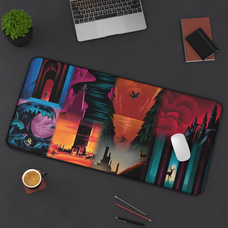 May include: A rectangular mouse mat with a fantasy landscape design in vivid colours. The artwork shows scenes including a person in an archway, a tower, a deer in a forest, and a castle. A white mouse rests on the mat.