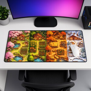 May include: A large rectangular mousepad featuring a pixelated illustration of a farm scene through the four seasons. The design includes houses, crops, and bodies of water. A white mouse rests on the winter scene.