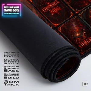 May include: A rolled-up black gaming mouse pad with a red and orange design. The pad features the text "COMMAND ZONE" and "LIBRARY". The pad has premium hemmed edges, an ultra-smooth surface, an anti-slip rubber base, and is 3mm thick.