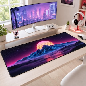 May include: A rectangular desk mat featuring a vibrant synthwave-inspired landscape with a glowing pink sun setting over dark blue, wireframe-style mountain peaks against a starry night sky, set on a light wood desk surface.