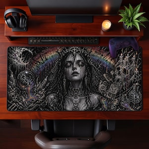 May include: A large black and white gaming mousepad featuring a gothic illustration of a woman with a crown, tears, and a rainbow. The design includes skulls, crystals, and a crystal ball.