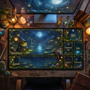 May include: A large rectangular mousepad featuring a fantasy scene with a frog wizard, a moonlit lake, and the words "Battlefield" and "Lands". The mousepad also has sections labeled "Life", "Command Zone", "Exile", "Library", and "Graveyard".