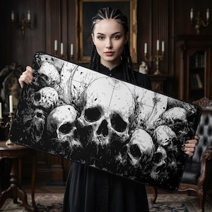 May include: A rectangular desk mat featuring a high-contrast black and white graphic illustration of multiple human skulls. The design includes intricate ink-style shading, splatter effects, and fine line work, creating a dense composition of skulls across the surface.