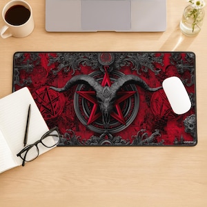May include: A rectangular mouse pad with a red background and a central design featuring a goat skull within a red pentagram. The design is framed by ornate black scrollwork. A white mouse is on the right.