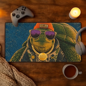 May include: A rectangular mousepad featuring a cartoon turtle wearing sunglasses, a gold chain, and an orange beanie with the word "CHILL". The mousepad has a blue background and the words "SLOW & STEADY" on a gold medallion.
