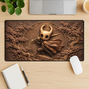 May include: A brown mousepad featuring a detailed relief of a character with a sword and cape, set against a backdrop of stylized trees and a circular frame. The design is in shades of brown and gold.