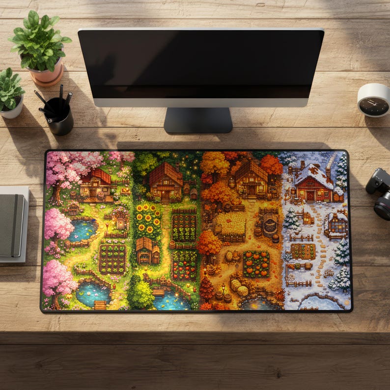 May include: Rectangular mousepad featuring a pixel art design of a farm scene through the four seasons. The design includes houses, gardens, ponds, and seasonal foliage. The mousepad is on a wooden desk.