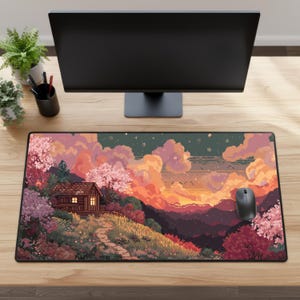 May include: A pixel art mousepad featuring a sunset landscape with a cabin, trees, and a path. The color palette includes pink, orange, and green hues. A black mouse sits on the right side of the pad. The mousepad is rectangular.