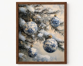 May include: A framed wall art print titled Little Pixel Gallery featuring four round Christmas ornaments with blue and white floral patterns hanging from snow-covered pine tree branches against a soft, light-colored winter background.