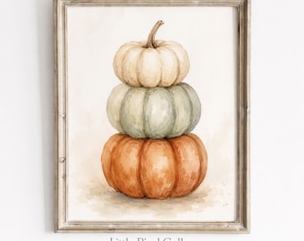Può includere: Una stampa ad acquerello incorniciata che mostra una pila verticale di tre zucche. La zucca in alto è color crema, quella centrale è verde salvia e quella in basso è arancione. L'opera è in una cornice di legno chiaro con il testo Little Pixel Gallery.