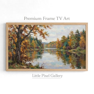 Könnte beinhalten: Ein Landschaftsgemälde in einem hellen Holzrahmen zeigt einen ruhigen Fluss, umgeben von herbstlichen Bäumen mit orangefarbenem, gelbem und grünem Laub. Der Text Premium Frame TV Art und Little Pixel Gallery steht über und unter dem Bild.