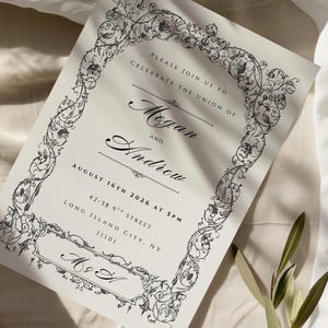 May include: An invitation card with ornate black floral border and text. The invitation reads "Please join us to celebrate the union of Megan and Andrew" with the date August 16th, 2026. The card also includes the address 42-38 9th Street, Long Island City, NY 11101.