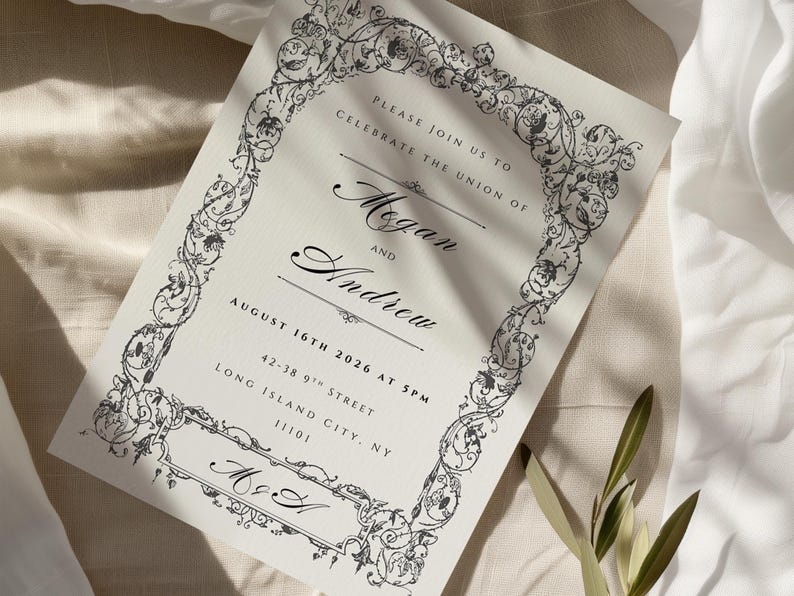 May include: An invitation card with ornate black floral border and text. The invitation reads "Please join us to celebrate the union of Megan and Andrew" with the date August 16th, 2026. The card also includes the address 42-38 9th Street, Long Island City, NY 11101.
