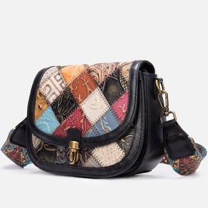 May include: A patchwork leather crossbody bag with a black base and strap. The flap features a colorful patchwork design with various textures and patterns. The bag has a gold-tone clasp and hardware.