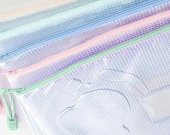May include: A collection of pastel-colored mesh zipper pouches. The pouches are in shades of white, pink, purple, blue, and green. Each pouch has a matching zipper and a small loop for easy opening. The mesh material allows for visibility of the contents.