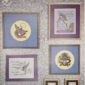May include: A book cover titled "Figments of Fantasy" featuring framed cross-stitch designs. The designs include a phoenix, a unicorn, a pegasus, and a dragon. The book is by Stephanie Seabrook Hedgepath.