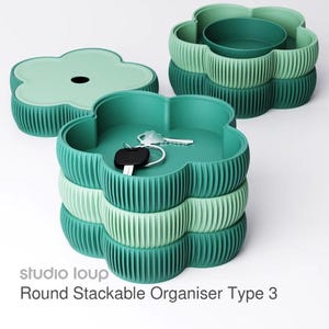 May include: A set of three ceramic mugs with a speckled, matte finish. The mugs are in shades of cream, gray, and black. Each mug has a simple, minimalist design, perfect for coffee or tea.
