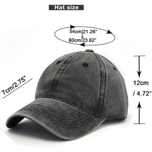 May include: A gray baseball cap with a curved brim. The hat's dimensions are 7cm/2.75" high, 12cm/4.72" deep, and a circumference of 54cm/21.26" to 60cm/23.62". The hat has a distressed, vintage look.