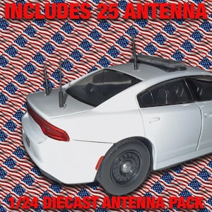 Op de afbeelding: Een witte gegoten modelauto met meerdere antennes op het dak. De tekst "INCLUDES 25 ANTENNA" en "1/24 DIECAST ANTENNA PACK" worden in het rood weergegeven. De achtergrond heeft een patroon van Amerikaanse vlaggen.