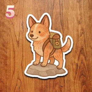 May include: A sticker featuring a cartoon-style dog with reddish-brown fur, wearing a backpack, standing on a rock. The number "5" is in the upper left corner. The background is a wood grain pattern.