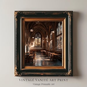 May include: Framed vintage art print featuring a detailed interior view of a cathedral or library with arched ceilings, stained glass windows, and wooden tables and chairs. The frame is black with gold accents. Text on the print reads "VINTAGE VANITÉ ART PRINT" and "Vintage Printable Art."