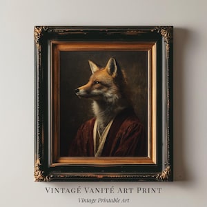 May include: A framed vintage art print depicting a fox in a red robe, in the style of a classic portrait. The artwork is set within a black and gold ornate frame. Text at the bottom reads "VINTAGE VANITÉ ART PRINT" and "Vintage Printable Art."
