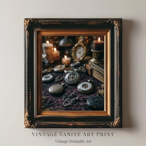 May include: Framed vintage art print featuring antique pocket watches, candles, and books on a dark purple surface. The print is in a decorative black and gold frame. Text at the bottom reads "VINTAGE VANITÉ ART PRINT" and "Vintage Printable Art."