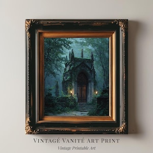 May include: Framed art print featuring a gothic building in a forest setting. The artwork is in a dark color palette with green and blue tones. The frame is black with gold accents. Text at the bottom reads "VINTAGE VANITE ART PRINT" and "Vintage Printable Art."