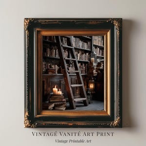 May include: Framed art print featuring a vintage library scene with a wooden ladder, stacks of books, and lit candles. The frame is black with gold accents. The text at the bottom reads "VINTAGE VANITÉ ART PRINT" and "Vintage Printable Art."