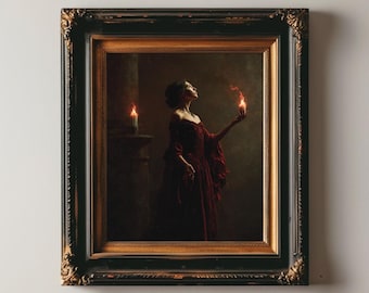 May include: A framed vintage art print featuring a woman in a red dress holding a flame. The artwork has a dark, moody aesthetic with text at the bottom that reads "VINTAGE VANITÉ ART PRINT" and "Vintage Printable Art". The frame is ornate with a black and gold finish.
