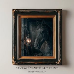 May include: A framed art print featuring a dark horse in a stable, illuminated by a lantern. The frame is ornate with gold and black detailing. Text at the bottom reads "VINTAGE VANITÉ ART PRINT" and "Vintage Printable Art."
