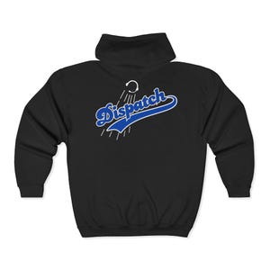 May include: A black zip-up hoodie featuring a graphic on the back. The design includes the word Dispatch in a blue script font with a white outline, positioned above a white icon of a headset with radiating lines, all set against the black fabric.