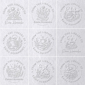 May include: A collection of nine white embossed library stamps. Each stamp features the text "FROM THE LIBRARY OF" and "Emma Hernandez" in a circular design. Various illustrations include books, flowers, and a skeleton.