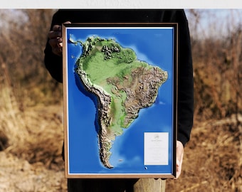 May include: 3D wall art of South America, framed in wood. The map features a detailed topographical representation with green, brown, and blue colors. The text at the top reads "3D USA MAP WALL ART". The bottom text reads "HOME DECOR GIFT".