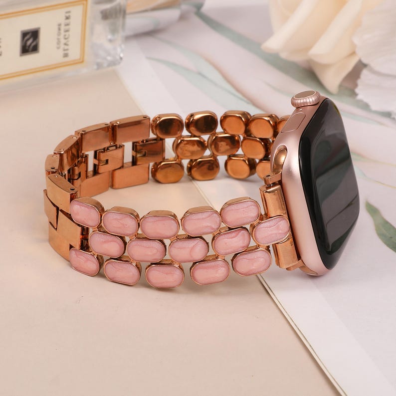 Chic gold iwatch strap for women, oval enamel links styled with workwear for a refined look.