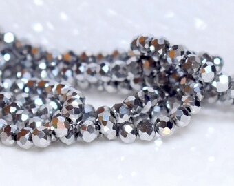 May include: A strand of silver faceted beads, perfect for jewelry making or crafting projects.