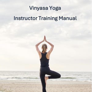 May include: A person in black athletic wear practices a yoga pose on a sandy beach with the ocean in the background. The text "Vinyasa Yoga Instructor Training Manual" is displayed at the top of the image.