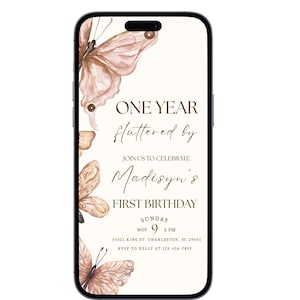 May include: A smartphone shows a birthday invitation with peach and brown watercolour butterflies. The text reads "ONE YEAR fluttered by" and "Madisyn's FIRST BIRTHDAY", with the date and time of the event.