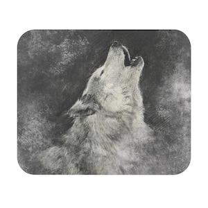 May include: A mousepad featuring a detailed pencil sketch of a howling wolf. The wolf is rendered in shades of gray and white, with a textured, fur-like appearance. The background is a dark, smoky gray.