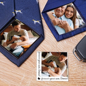 May include: Navy blue neckties with custom photo inserts. One tie features a repeating pattern of white and yellow dogs. The other tie has a photo of a smiling couple. A small photo card reads "forever your son, Daniel."