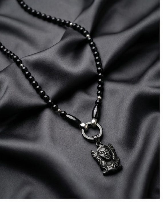 Elegant women's pearl necklace made of onyx stone with stainless steel elements and a stylish Buddha pendant.